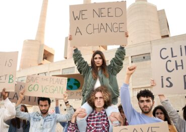 People with banners protest as part of a climate change march.