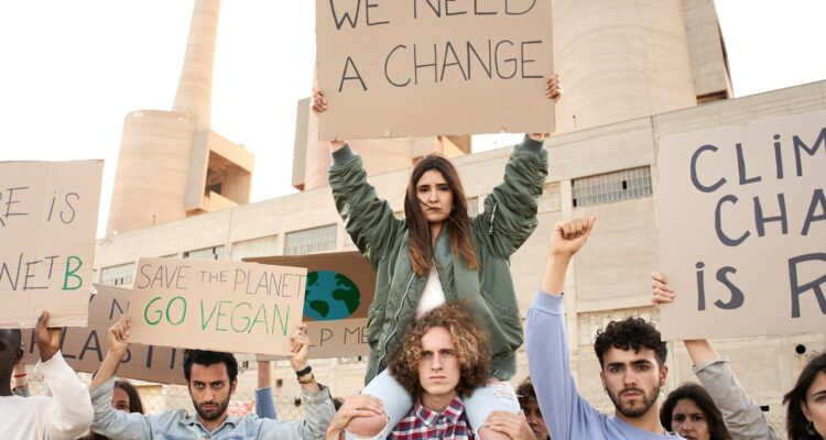 People with banners protest as part of a climate change march.