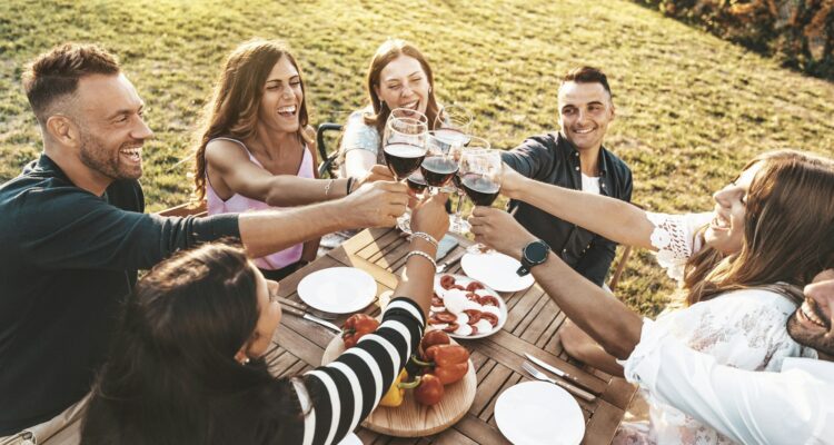 Group of friends having fun at bbq outside dinner in home garden